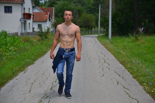 Shirtless Serbian boy in his village
