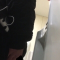 A male is pissing in the toilet.